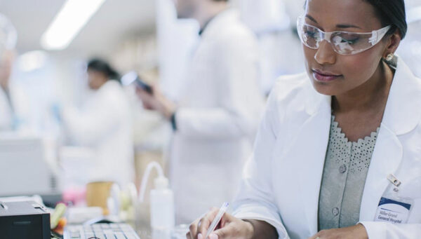 MS in Health Sciences graduate reviewing laboratory regulations document