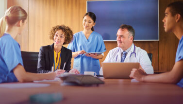 Allied health professionals meeting around a conference room table