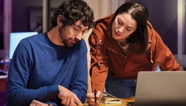 Man and woman doing homework at the kitchen table