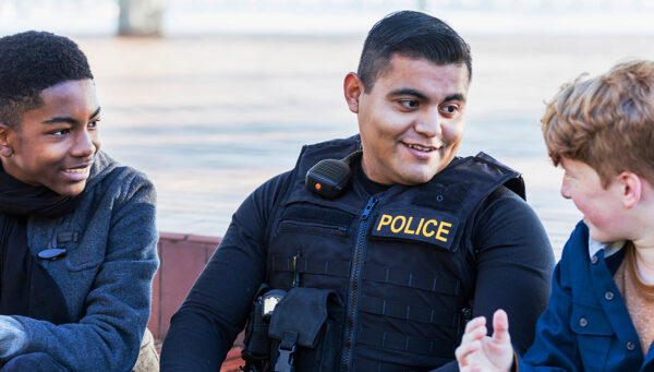 police officer speaking to two children