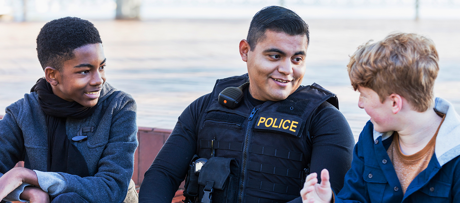 police officer speaking to two children