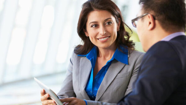 two colleagues looking at a tablet.