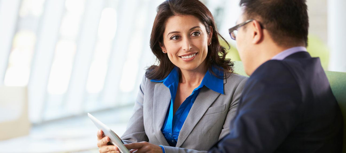 two colleagues looking at a tablet.